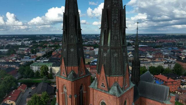 Drone footage of Uppsala Cathedral and cityscape with houses in Swedan