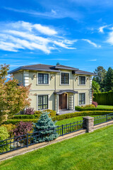 Two story stucco luxury house with nice summer  landscape in Vancouver, Canada, North America. Day time on June 2024.