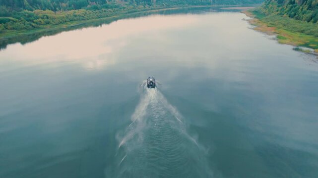 The airboat is launched and gaining momentum. Universal water transport for trips in shallow water. A large screw.