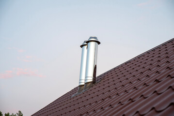 Stainless steel chimney smokestack pipe on the roof