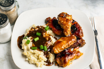 barbecue chicken wings with mash potatoes.