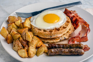 fried eggs on stack waffles   with home fries