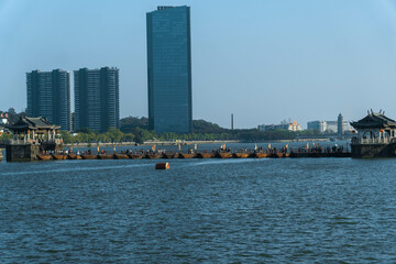 A modern cityscape blended with traditional architecture, elegantly situated over water
