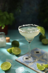A glass with margarita cocktail with lime