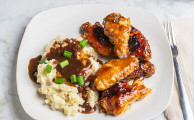 barbecue chicken wings with mash potatoes.