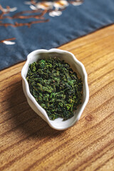 Aromatic Dried Green Herb Displayed in an Elegant Dish on a Beautiful Wooden Table Surface