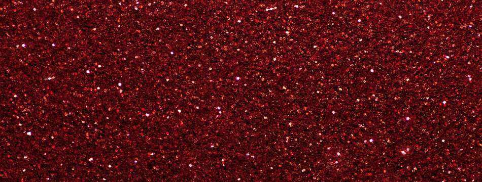 Dark red sparkling background from small sequins, macro. Wine shiny backdrop with glitter pattern.