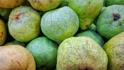 Guava fruits (Psidium Guajava). Close up of green Guava fruits in group and sale in fresh market. Tropical fruits. 