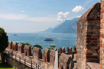 Aerial view of idyllic coastline of Lake Garda seen from defensive walls of medieval Scaliger...