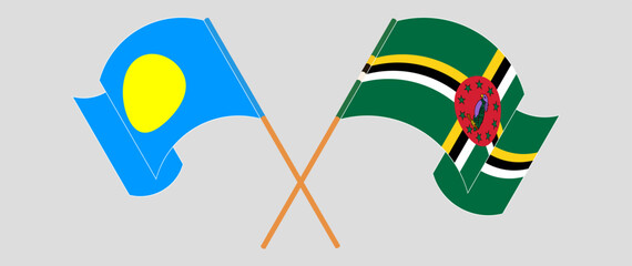Crossed and waving flags of Palau and Dominica. Vector illustration