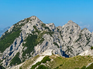 Scenic view of rugged mountain peak Piper seen from top of Jof di Miezegnot. Surrounded by majestic ridges of Carnic and Julian Alps, Friuli Venezia Giulia, Italy. Wanderlust Italian Alps in summer