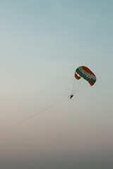 Goa beach Parasailing extreme sports on beach in blue sky background. Parasailing activity on beautiful beach during the day parachute like flying