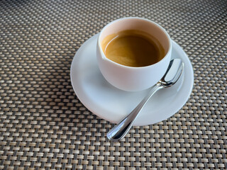 Elegant morning espresso in a white cup, perfectly captured to emphasize a fresh start and simplicity.