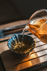 Pouring tea into a beautifully crafted bowl creates a serene moment of elegance and calm