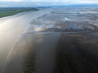 Aerial view of a tidal channel and mudflats near Termunterzijl, Groningen, The Netherlands