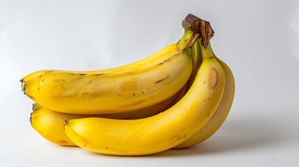 A bunch of ripe yellow bananas arranged artistically on a white background.