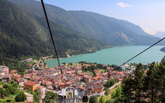 Cable car Funivie Molveno Pradel overlooking mountain retreat town Molveno and alpine lake Lago di Molveno in Trentino, Italy. Surrounded by forest and mountains of Brenta Dolomites. Tourism in Alps