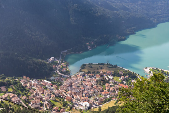 Cable car Funivie Molveno Pradel overlooking mountain retreat town Molveno and alpine lake Lago di Molveno in Trentino, Italy. Surrounded by forest and mountains of Brenta Dolomites. Tourism in Alps
