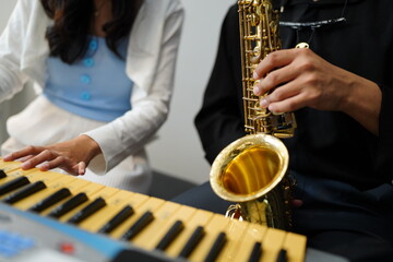 Naklejka premium Working Asians are learning international musical skills at home