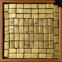 An Artistic Collection of Gleaming Gold Bars Elegantly Arranged within a Square Frame Design