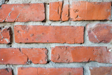 Close-up view of an old brick wall with aged bricks and mortar.