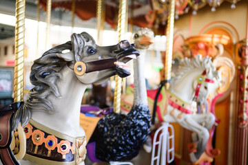 Beautiful carnival fair carousel with animals and yellow lights
