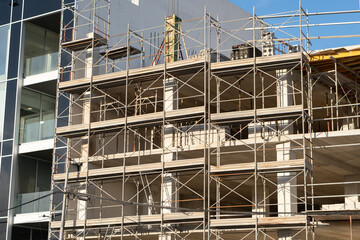 Tower Crane on building construction. Construction crane on Housing. Construction site, Multi Storey Residential Buildings construction. Formworks. Modern Townhome building. Modern House building.