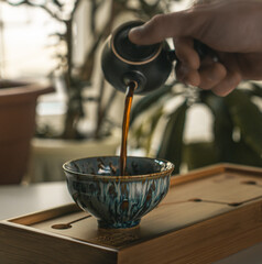 Experience the elegance and artistry of tea pouring in a beautifully serene setting