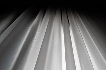 White silk curtains in the house near window