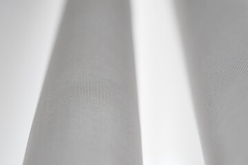 White silk curtains in the house near window