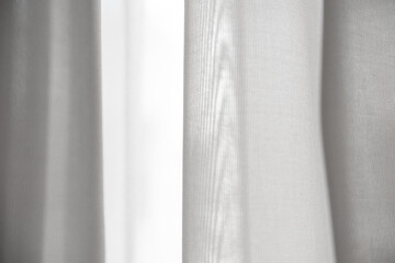 White silk curtains in the house near window