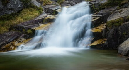 Fototapeta premium Serene waterfall cascade in lush mountain landscape