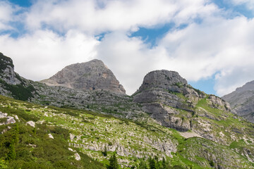 Fototapeta premium Scenic view of cloud covered rocky rugged mountain peak of Cima Dei Lasteri in majestic Brenta Dolomites, Trentino, Italy. Wanderlust in alpine wilderness. Hiking in pristine Italian Alps in summer