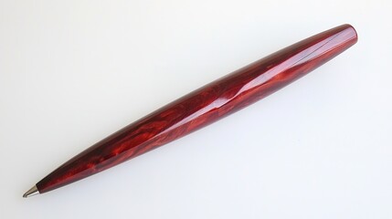 A sleek, elegant red pen rests on a white surface, showcasing its smooth finish and sophisticated design, perfect for writing or gifting.