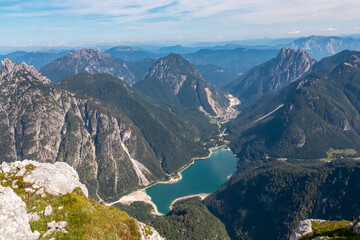 On top of Cima Del Lago with aerial view of alpine lake Lago Del Predil in Val Canale surrounded by...