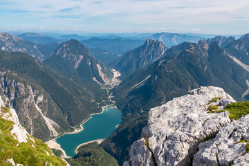 On top of Cima Del Lago with aerial view of alpine lake Lago Del Predil in Val Canale surrounded by...