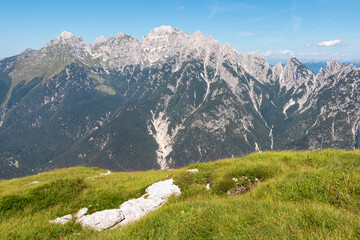 Scenic view of pristine rugged mountain peaks of Western Julian Alps, Italy, Europe. Wild hiking trail along majestic ridges in Triglav National Park. Wanderlust in alpine wilderness in summer. Awe