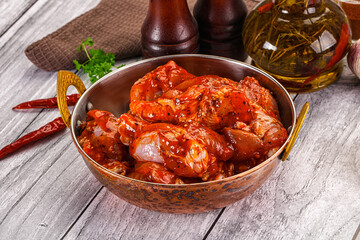 Raw marinated buffalo chicken wings