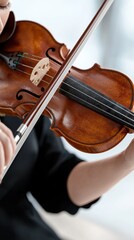 Fototapeta premium Woman playing violin in modern studio capturing resonant music indoor space close-up perspective artistic expression