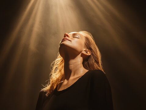 A woman sings passionately on stage concert hall performance dramatic lighting close-up empowering voice and emotion