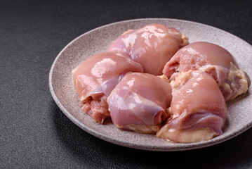 Fresh raw chicken thigh fillets with salt, spices and herbs