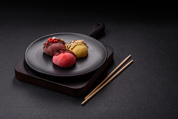 Delicious colorful asian mochi sweets with rice dough shell and fruit filling