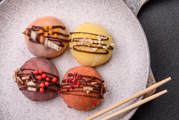 Delicious colorful asian mochi sweets with rice dough shell and fruit filling