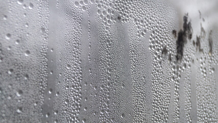 Water drops on a foggy window. A pile of drops on the glass