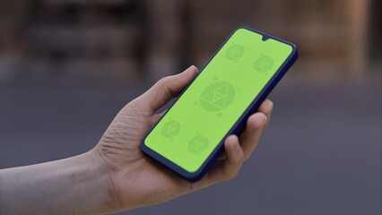 Caucasian White middle aged male using smartphone with a blank green screen. Mobile app video mockup. Vertical phone orientation