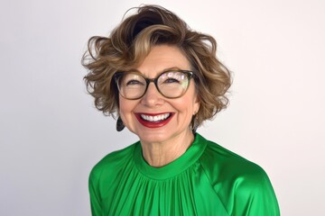 Fototapeta premium Mature caucasian female smiling in green blouse with glasses and curly hair