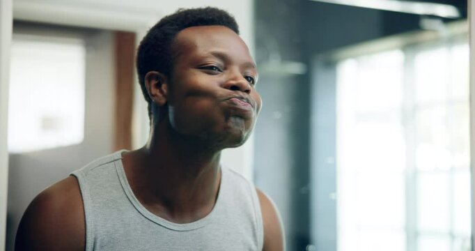 Hygiene, routine and man in bathroom, mouthwash and cleaning of mouth, dental care and oral health. Morning, mirror and rinsing of teeth with water, black person and grooming for wellness in house