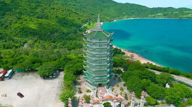 The Thap Xa Loi temple showcases dramatic architecture surrounded by lush greenery and coastal waters, highlighting the serene beauty of Da Nang's landscape.