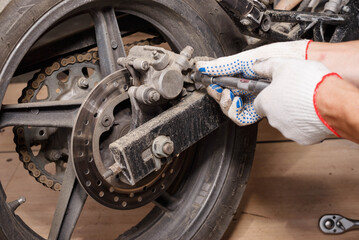 The process of replacing brake pads on a motorcycle.
