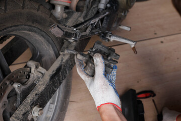 The process of replacing brake pads on a motorcycle.